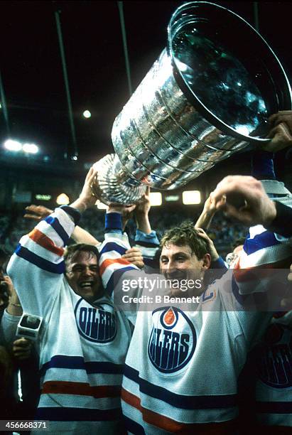 Wayne Gretzky of the Edmonton Oilers celebrates with the Stanley Cup after the Oilers defeated the Philadelphia Flyers in Game 7 of the 1987 Stanley...