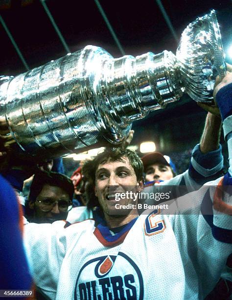 Wayne Gretzky of the Edmonton Oilers celebrates with the Stanley Cup after the Oilers defeated the Philadelphia Flyers in Game 7 of the 1987 Stanley...