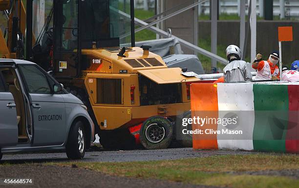 Jules Bianchi of France and Marussia receives urgent medical treatment after crashing during the Japanese Formula One Grand Prix at Suzuka Circuit on...