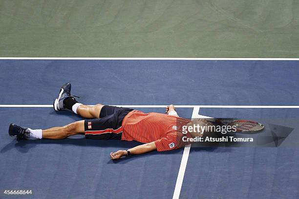 Kei Nishikori of Japan lies on the court after winning the men's singles final match against Milos Raonic of Canada on day seven of Rakuten Open 2014...