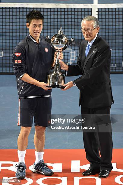 Kei Nishikori of Japan and Japan Tennis Association chairman Nobuo Kuroyanagi pose with winner's trophy with after the men's singles final match on...