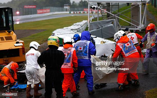 Jules Bianchi of France and Marussia receives urgent medical treatment after crashing during the Japanese Formula One Grand Prix at Suzuka Circuit on...