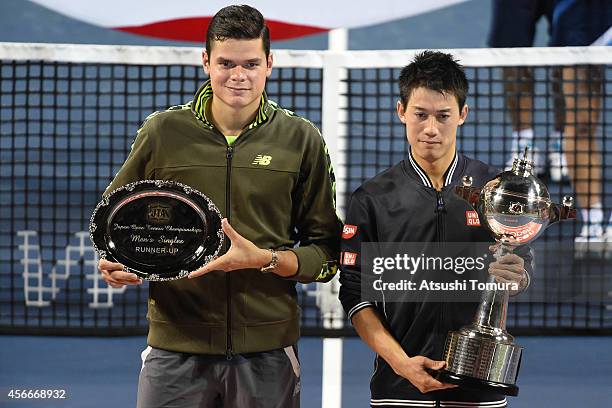 Winner Kei Nishikori of Japan and runner-up Milos Raonic of Canada celebrate with trophy and plate after the men's singles final match against on day...