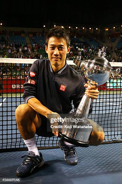 Winner Kei Nishikori of Japan celebrates with his trophy after winning the men's singles final match against Milos Raonic of Canada on day seven of...