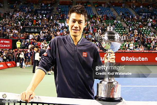 Winner Kei Nishikori of Japan poses with his trophy after winning the men's singles final match against Milos Raonic of Canada on day seven of...