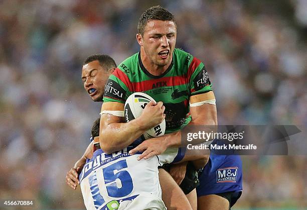 Sam Burgess of the Rabbitohs is tackled during the 2014 NRL Grand Final match between the South Sydney Rabbitohs and the Canterbury Bulldogs at ANZ...