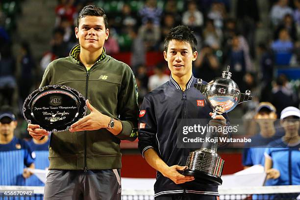 Winner Kei Nishikori of Japan and runner-up Milos Raonic of Canada pose for photoragraphs at the trophy ceremony after the men's singles final match...