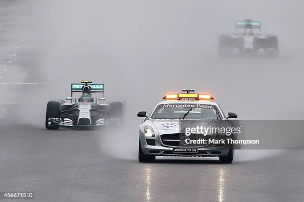 Nico Rosberg of Germany and Mercedes GP leads teammate Lewis Hamilton of Great Britain and Mercedes GP under the safety car during the Japanese...