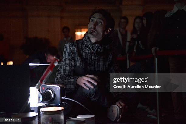 Artist Hicham Berrada presents his installation 'Presage' a video performance piece during Nuit Blanche 2014 at Hotel de Ville on October 4, 2014 in...