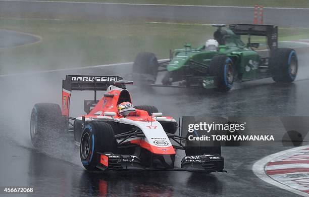 Marussia driver Jules Bianchi of France leads Caterham driver Kamui Kobayashi of Japan at the Formula One Japanese Grand Prix in Suzuka on October 5,...