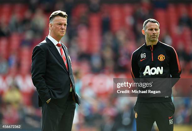 Manchester United Manager Louis van Gaal looks on with Assistant Ryan Giggs prior to the Barclays Premier League match between Manchester United and...