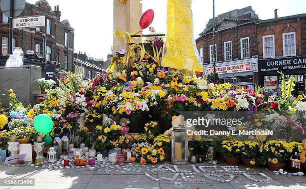 General view of flowers left at the Hanwell clock tower in memory of Alice Gross on October 5, 2014 in London, England. A body believed to be that of...