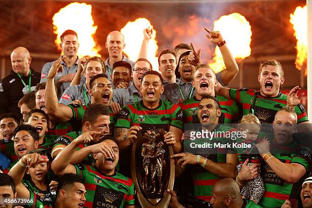 Rabbitohs captain John Sutton celebrates on the podium with his team mates after winning the 2014 NRL Grand Final match between the South Sydney...