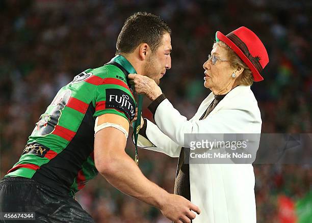 Sam Burgess of the Rabbitohs is presented with the Clive Churchill medal by Joyce Churchill after the 2014 NRL Grand Final match between the South...