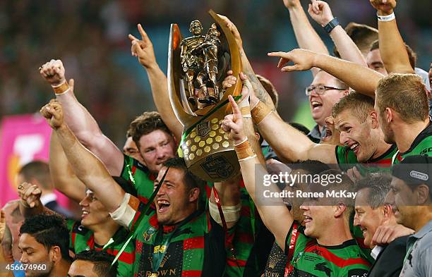 Souths players celebrate with the Provan Summons trophy after their teams win at the 2014 NRL Grand Final match between the South Sydney Rabbitohs...
