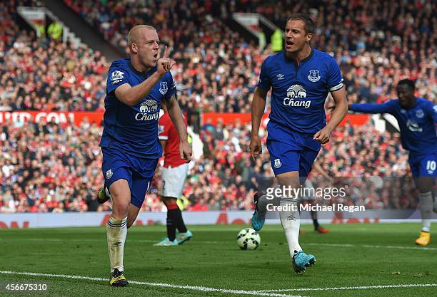 Steven Naismith of Everton celebrates scoring his team's first goal during the Barclays Premier League match between Manchester United and Everton at...