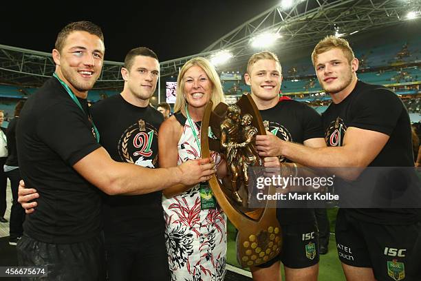 Sam Burgess; Luke Burgess, Julie Burgess, George Burgess and Thomas Burgess of the Rabbitohs hold the trophy as they celebrate victory during the...