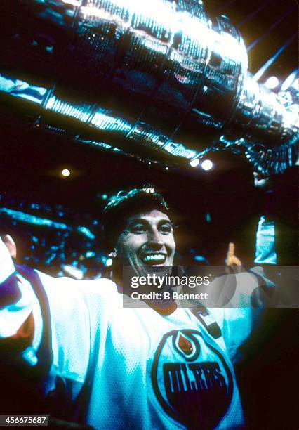 Wayne Gretzky of the Edmonton Oilers celebrates with the Stanley Cup Trophy after the Oilers defeated the Philadelphia Flyers in Game 5 of the 1985...