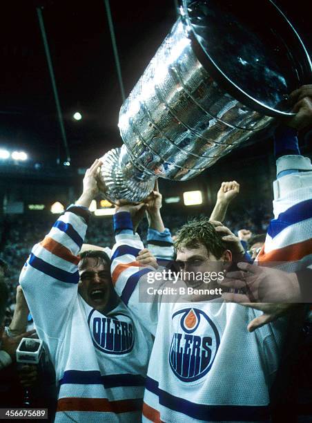 Wayne Gretzky of the Edmonton Oilers celebrates with the Stanley Cup after the Oilers defeated the Philadelphia Flyers in Game 7 of the 1987 Stanley...