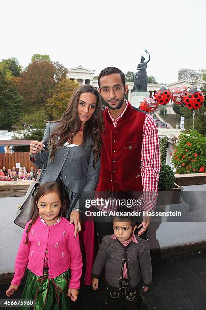 Mehdi Benatia attends with his wife Cecile Benatia and their children Kays and Lina during the Oktoberfest beer festival at Kaefer Wiesnschaenke tent...