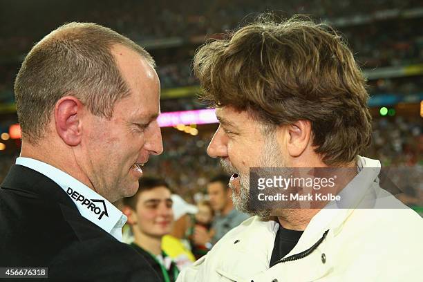 Rabbitohs coach Michael Maguire speaks to Russell Crowe after victory during the 2014 NRL Grand Final match between the South Sydney Rabbitohs and...