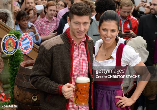 Bayern Munich's Polish striker Robert Lewandowski and his wife Anna Stachurska arrive for the traditional visit of German first division football...