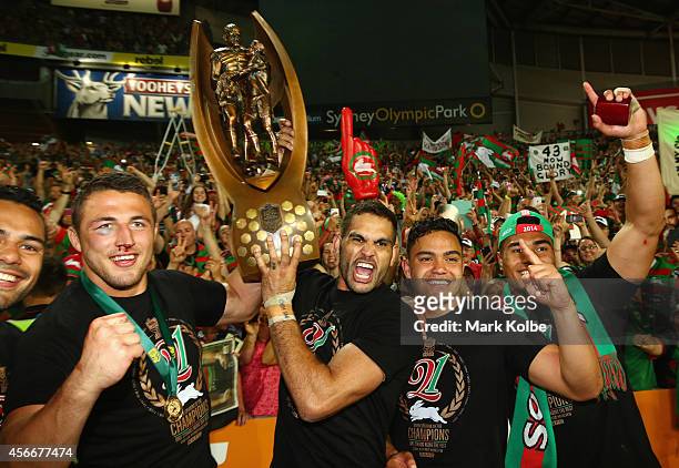 Sam Burgess, Greg Inglis and Dylan Walker of the Rabbitohs pose with the trophy in front of the crowd after victory during the 2014 NRL Grand Final...
