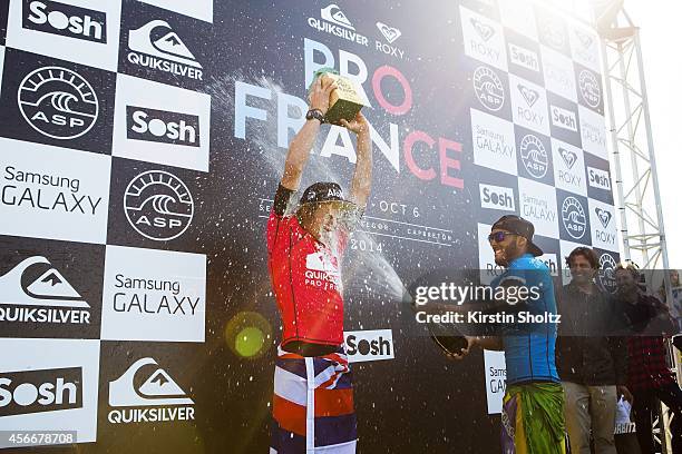 John John Florence of Hawaii is douced in champange by runner up Jadson Andre of Brasil during the prizegiving of the Quiksilver Pro France on...