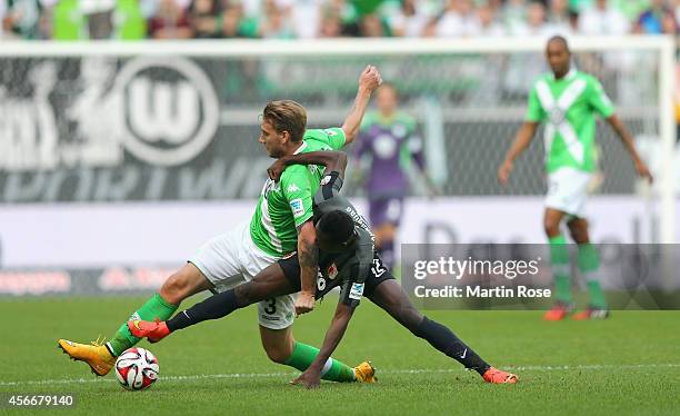 Nicklas Bendtner of Wolfsburg and Abdul Rahman Baba of Augsburg battle for the ball during the Bundesliga match between VfL Wolfsburg and FC Augsburg...