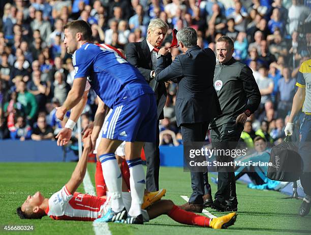 Managers Arsene Wenger of Arsenal and Jose Mourinho of Chelsea clash after a foul on Arsenal's Alexis Sanchez during the Barclays Premier League...