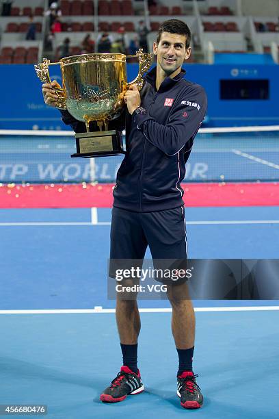 Novak Djokovic of Serbia poses with the trophy after winning the men's singles final match against Tomas Berdych of the Czech Republic during day...