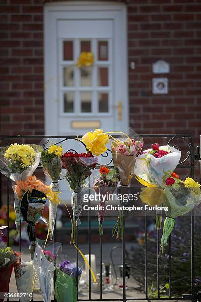 Floral tributes lay at the front door of murdered British aid worker Alan Henning on October 5, 2014 in Salford, England. Residents and friends are...