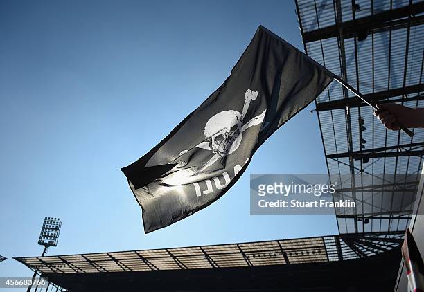 Fan of St. Pauli waves a flag during the Second Bundesliga match between FC St. Pauli and 1. FC Union Berlin at Millerntor Stadium on October 4, 2014...