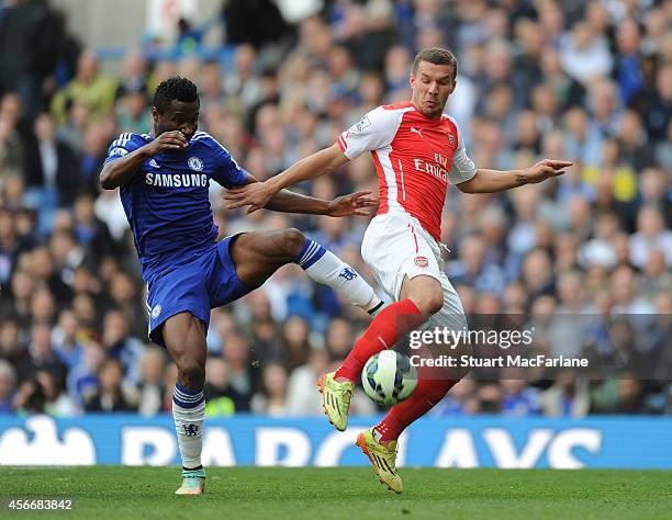 Lukas Podolski of Arsenal challenged by John Mikel Obi of Chelsea during the Barclays Premier League match between Chelsea and Arsenal at Stamford...