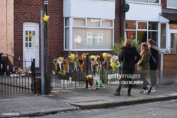 Floral tributes for murdered aid worker Alan Henning are placed outside his home in Eccles, north west England on October 5, 2014. Britain united in...