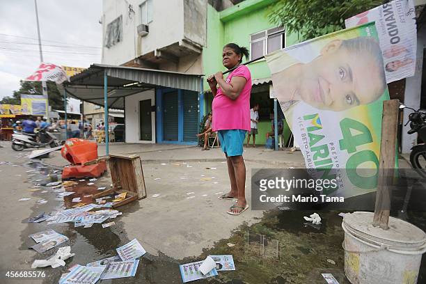 Marina Silva supporter holds a campaign flag in the Complexo da Mare favela, or community, on the day of national elections on October 5, 2014 in Rio...