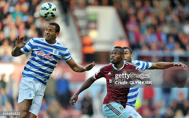 Queens Park Rangers' English defender Rio Ferdinand vies with West Ham United's Senegalese striker Diafra Sakho during the English Premier League...