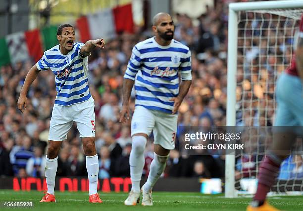 Queens Park Rangers' English defender Rio Ferdinand gestures during the English Premier League football match between West Ham United and Queens Park...