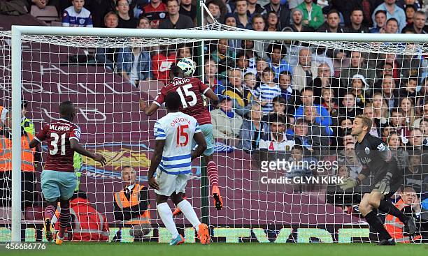 West Ham United's Senegalese striker Diafra Sakho scores their second goal as Queens Park Rangers' English goalkeeper Robert Green looks on during...