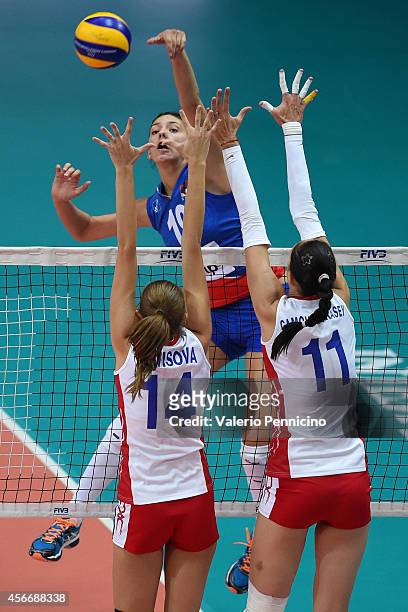 Tijana Boskovic of Serbia spikes as Ekaterina Gamova and Irina Fetisova of Russia block during the FIVB Women's World Championship pool F match...