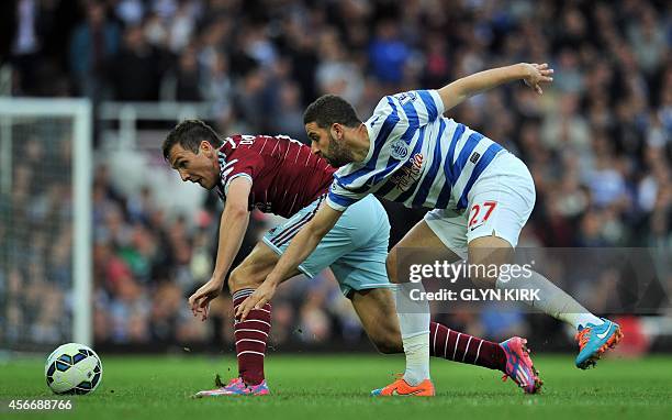 West Ham United's English midfielder Stewart Downing vies with Queens Park Rangers' Moroccan midfielder Adel Taarabt during the English Premier...