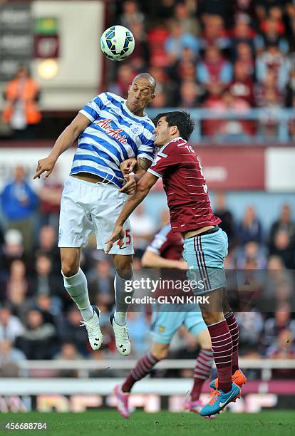 West Ham United's English defender James Tomkins vies with Queens Park Rangers' English striker Bobby Zamora during the English Premier League...