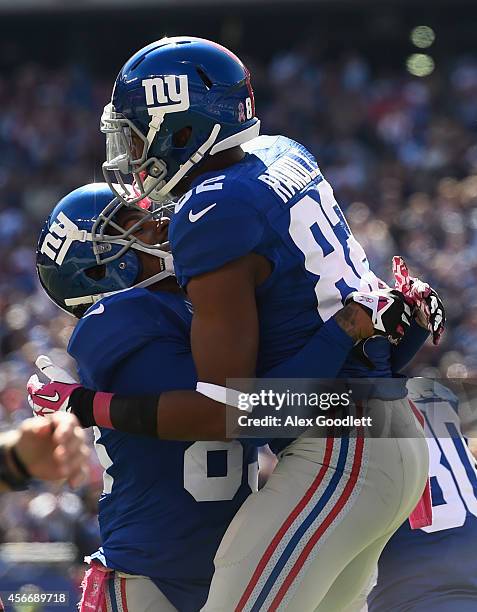 Wide receiver Rueben Randle of the New York Giants celebrates with teammate Preston Parker after catching a three yard pass by quarterback Eli...