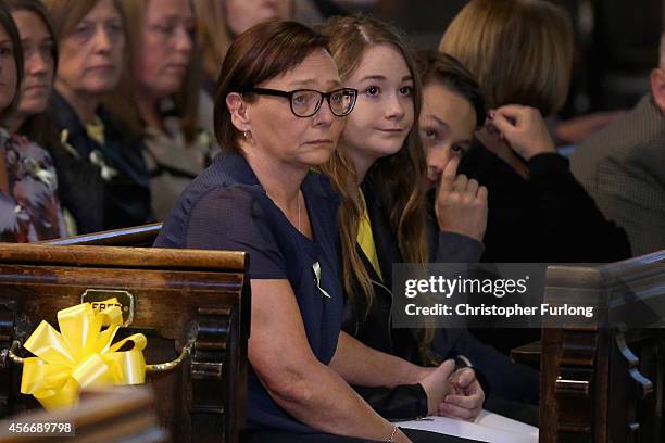 Barbara Henning , wife of murdered aid volunteer Alan Henning, sits with family members as they attend a 'service of reflection' to honour his life...
