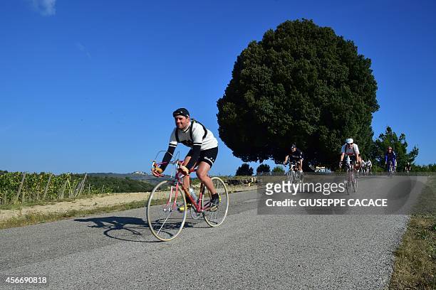Bike enthusiasts ride during L'Eroica, a retro cycling event on October 5, 2014 in Gaiole in Chianti near Siena. More than 5000 competitors from all...