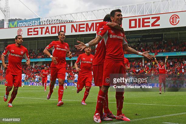 Edgar Benitez of Toluca celebrate with teammates after scoring the opening goal of his team during a match between Toluca and Puebla as part of 12th...