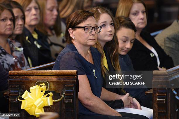 Barbara Henning , the wife of murdered British aid worker Alan Henning, and their children, Lucy and Adam, attend a quiet service of remembrance for...