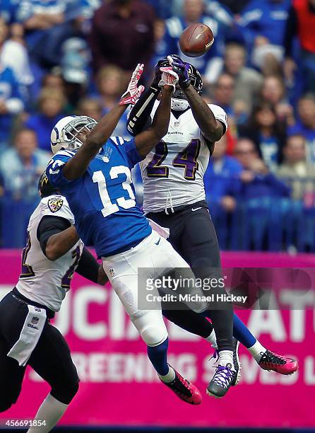Hilton of the Indianapolis Colts and Darian Stewart of the Baltimore Ravens battle for the ball at Lucas Oil Stadium on October 5, 2014 in...