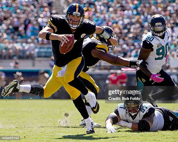Ben Roethlisberger of the Pittsburgh Steelers scrambles after avoiding a tackle by Roy Miller of the Jacksonville Jaguars during the second quarter...