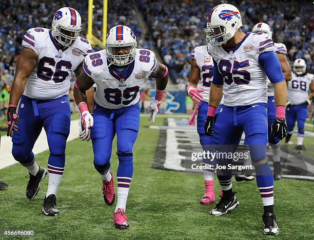 Chris Gragg, Seantrel Henderson and Lee Smith of the Buffalo Bills celebrate a fourth quarter touchdown against the Detroit Lions at Ford Field on...